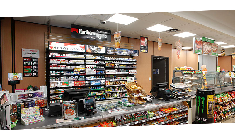  Front checkout counter with cigarettes on sale behind.  