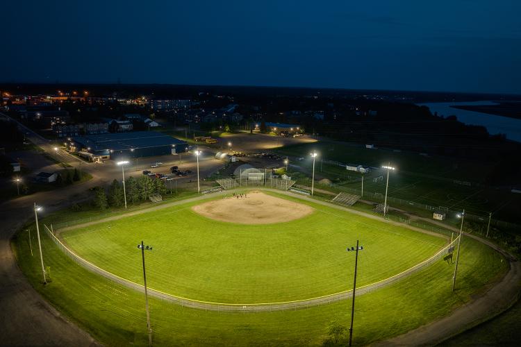 Drone view from above center field of powerful LED Lamps lighting Harold Page Field