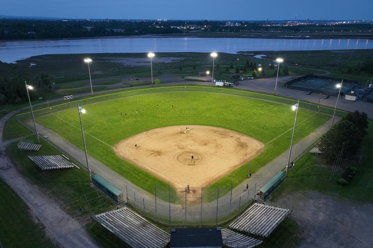 Drone view at dusk of powerful LED Lamps lighting Harold Page Field